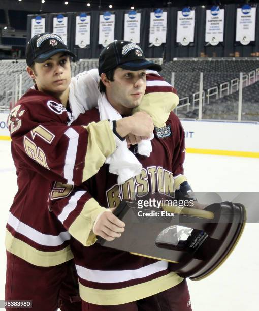 Steven Whitney and Joe Whitney of the Boston College Eagles celebrate with the trophy after the championship game of the 2010 NCAA Frozen Four on...