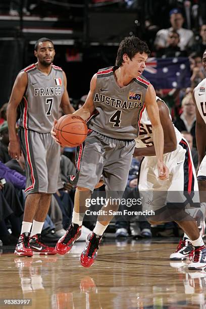 Jason Cadee of the World Select Team looks for an opening around Kyrie Irving of the USA Junior National Select Team on April 10, 2010 at the Rose...