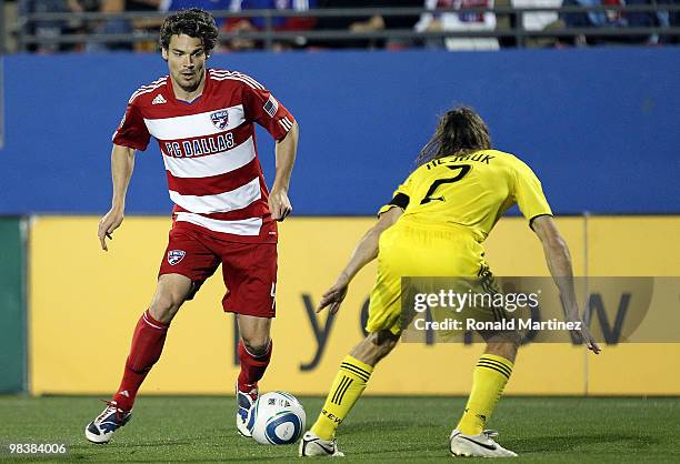 Defender Heath Pearce of FC Dallas dribbles the ball past Frankie Hejduk of the Columbus Crew at Pizza Hut Park on April 10, 2010 in Frisco, Texas.