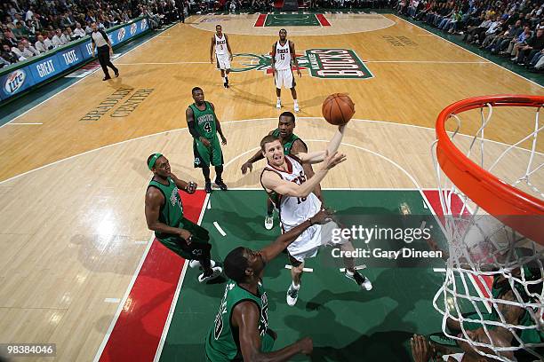 Luke Ridnour of the Milwaukee Bucks shoots a layup against Michael Finley of the Boston Celtics on April 10, 2010 at the Bradley Center in Milwaukee,...