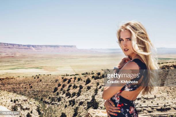 blonde girl in front of vermillioncliffs kmphoto - vermillion stock pictures, royalty-free photos & images