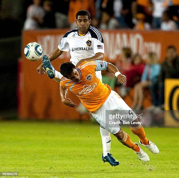 Danny Cruz of the Houston Dynamo dives for a header as Sean Franklin of the Los Angeles Galaxy gets his boot up on April 10, 2010 in Houston, Texas.