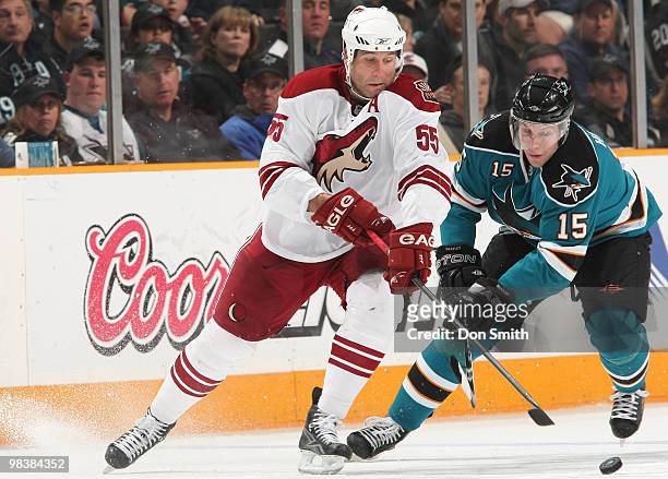 Ed Jovanovski of the Phoenix Coyotes looks for the puck against Dany Heatley of the San Jose Sharks during an NHL game on April 10, 2010 at HP...