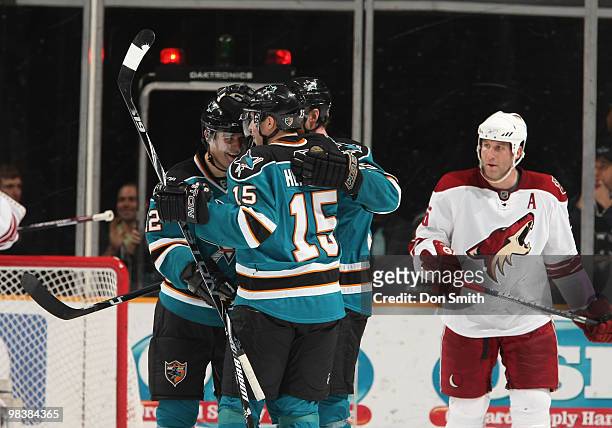 Ed Jovanovski of the Phoenix Coyotes reacts to a goal by Patrick Marleau as Joe Thornton and Dany Heatley of the San Jose Sharks celebrate during an...