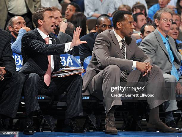 Assistant coach Chad Iske yells instructions as assistant coach Adrian Dantely of the Denver Nuggets watches play during the game against the San...