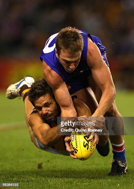 Chance Bateman of the Hawks and Liam Picken of the Bulldogs contest for the ball during the round three AFL match between the Western Bulldogs and...