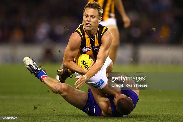 Sam Mitchell of the Hawks is tackled by Matthew Boyd of the Bulldogs during the round three AFL match between the Western Bulldogs and the Hawthorn...