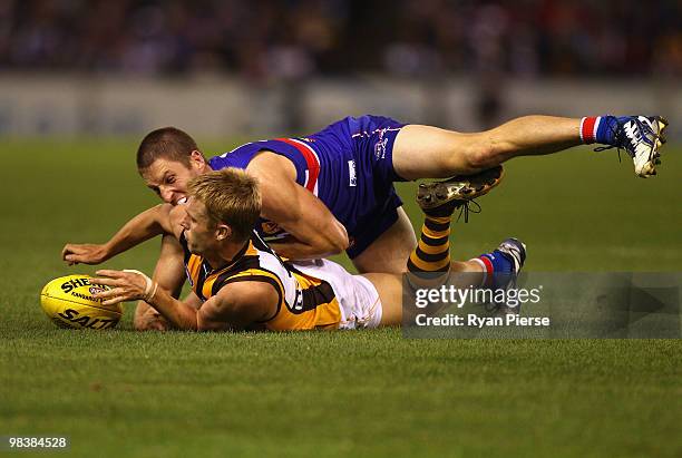 Sam Mitchell of the Hawks is tackled by Matthew Boyd of the Bulldogs during the round three AFL match between the Western Bulldogs and the Hawthorn...