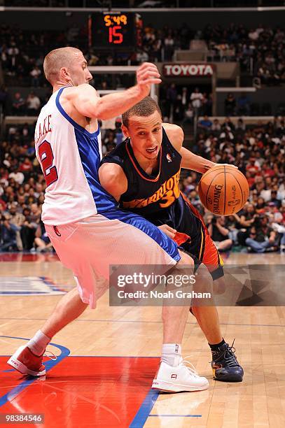 Stephen Curry of the Golden State Warriors drives to the hoop against Steve Novak of the Los Angeles Clippers at Staples Center on April 10, 2010 in...