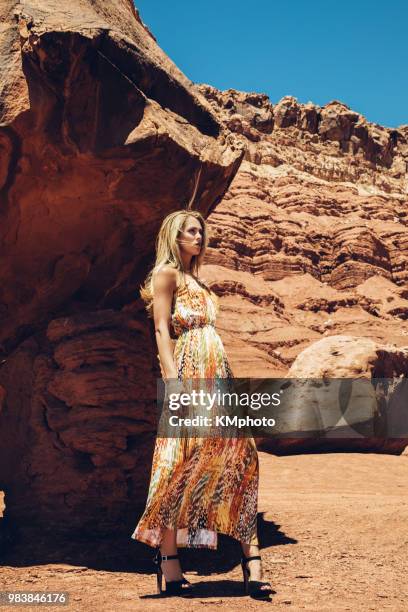 blonde girl in long dress near giant rocks kmphoto - kmphoto stock pictures, royalty-free photos & images