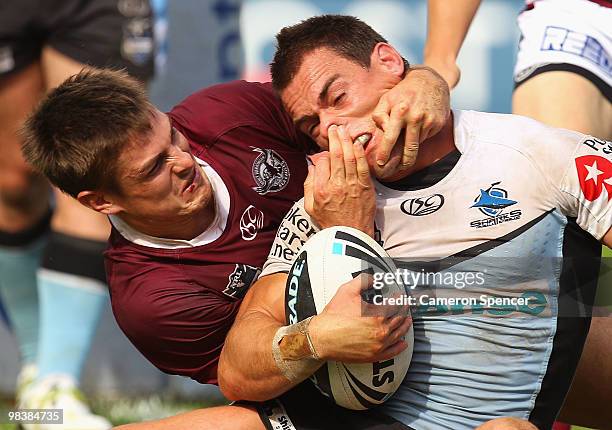 John Morris of the Sharks is tackled by Matt Ballin of the Sea Eagles during the round five NRL match between the Manly Sea Eagles and the Cronulla...