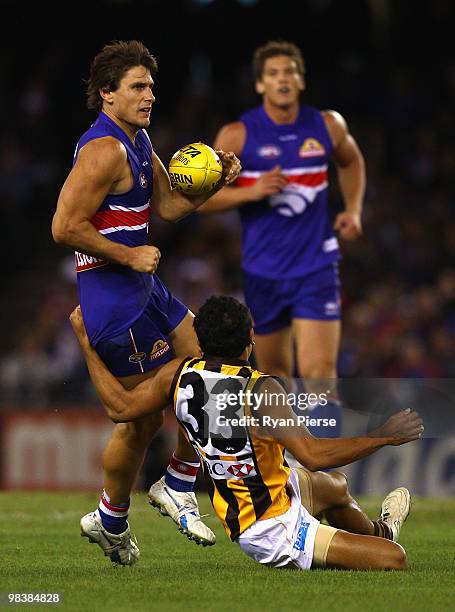 Ryan Griffin of the Bulldogs is tackled by Cyril Rioli of the Hawks during the round three AFL match between the Western Bulldogs and the Hawthorn...