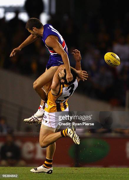 Jarrod Harbrow of the Bulldogs clashes with Jordan Lewis of the Hawks during the round three AFL match between the Western Bulldogs and the Hawthorn...