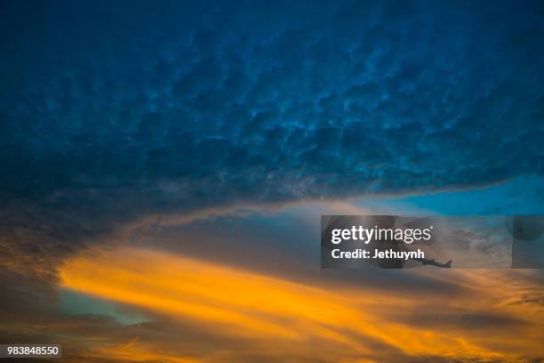 dramatic sky and airplane in the sunset - jethuynh stock pictures, royalty-free photos & images