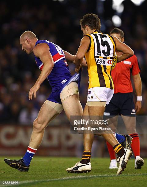 Luke Hodge of the Hawks pulls at the shorts of Barry Hall of the Bulldogs during the round three AFL match between the Western Bulldogs and the...