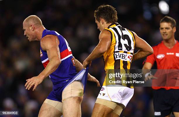 Luke Hodge of the Hawks pulls at the shorts of Barry Hall of the Bulldogs during the round three AFL match between the Western Bulldogs and the...