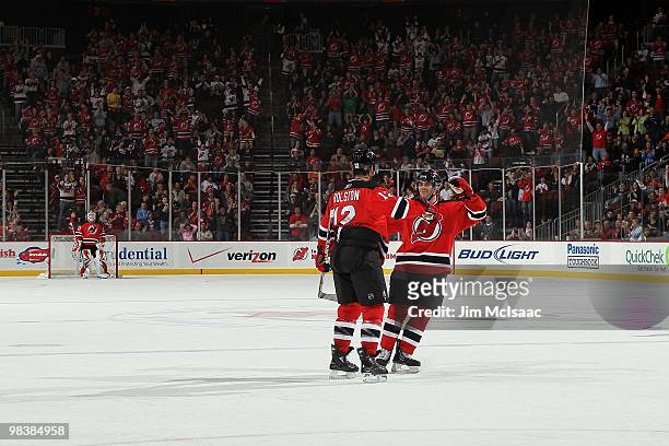 Brian Rolston of the New Jersey Devils celebrates his goal against the New York Islanders with teammate Andy Greene at the Prudential Center on April...