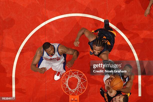 Baron Davis of the Los Angeles Clippers goes up for a shot against Ronny Turiaf and Stephen Curry of the Golden State Warriors at Staples Center on...