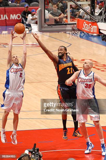 Steve Blake of the Los Angeles Clippers reaches for a rebound against Ronny Turiaf of the Golden State Warriors at Staples Center on April 10, 2010...
