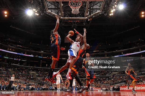 Rasual Butler of the Los Angeles Clippers has his shot challenged by Ronny Turiaf of the Golden State Warriors at Staples Center on April 10, 2010 in...