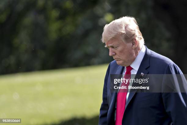 President Donald Trump walks on the South Lawn of the White House before boarding Marine One in Washington, D.C., U.S., on Monday, June 25, 2018....