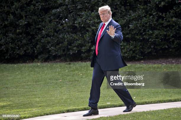 President Donald Trump waves while walking on the South Lawn of the White House before boarding Marine One in Washington, D.C., U.S., on Monday, June...