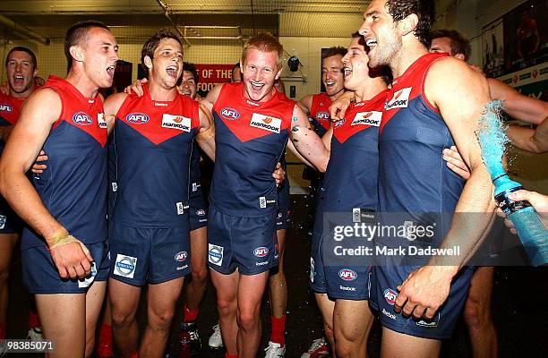 Melbourne players celebrate as they sing the team song after winning the round three AFL match between the Melbourne Demons and the Adelaide Crows at...