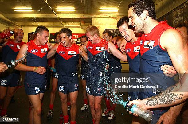 Melbourne players celebrate as they sing the team song after winning the round three AFL match between the Melbourne Demons and the Adelaide Crows at...