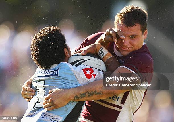 Albert Kelly of the Sharks is tackled by Anthony Watmough of the Sea Eagles during the round five NRL match between the Manly Sea Eagles and the...