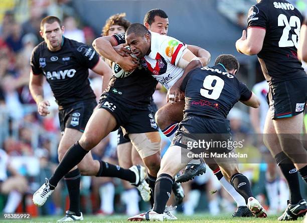 Lopini Paea of the Roosters is tackled during the round five NRL match between the Penrith Panthers and the Sydney Roosters at CUA Stadium on April...