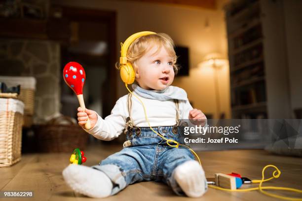 little boy with earphones, listening music and plying musical in - plying stock pictures, royalty-free photos & images