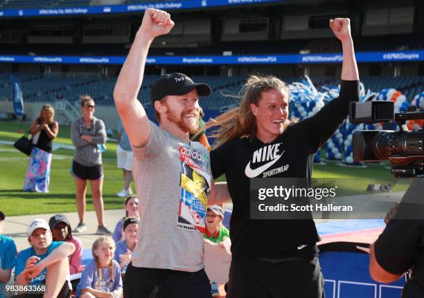 Soccer players Dax McCarty and Alyssa Naeher celebrate on the field of Soldier Stadium after winning the KPMG Windy City Skills Challenge prior to...