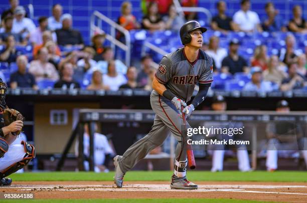 Jake Lamb of the Arizona Diamondbacks hits a home run in the first inning during the game against the Miami Marlins at Marlins Park on June 25, 2018...