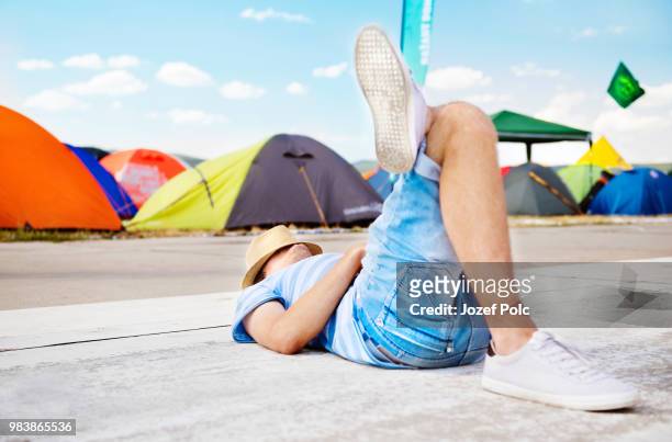 unrecognizable on summer music festival, lying on concrete path. - outside lands music festival day 1 stock-fotos und bilder