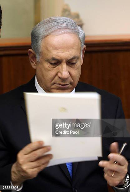 Israeli Prime Minister Benjamin Netanyahu reads a document the weekly cabinet meeting at his office on April 11, 2010 in Jerusalem, Israel....
