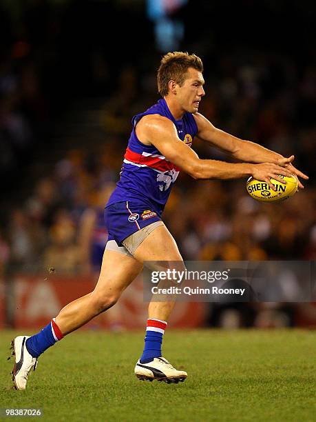 Shaun Higgins of the Bulldogs kicks during the round three AFL match between the Western Bulldogs and the Hawthorn Hawks at Etihad Stadium on April...