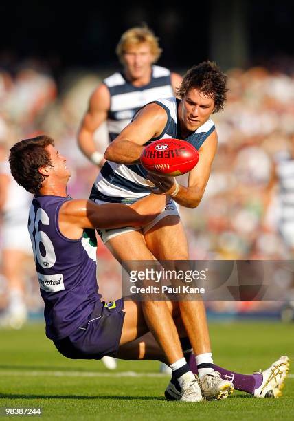 Alex Silvagni of the Dockers tackles Andrew Mackie of the Cats during the round three AFL match between Fremantle Dockers and the Geelong Cats at...