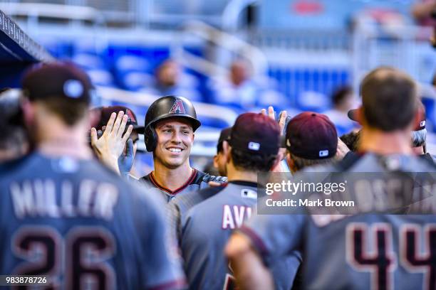 Jake Lamb of the Arizona Diamondbacks celebrates with teammates in the dugout after hitting a home run in the first inning during the game against...