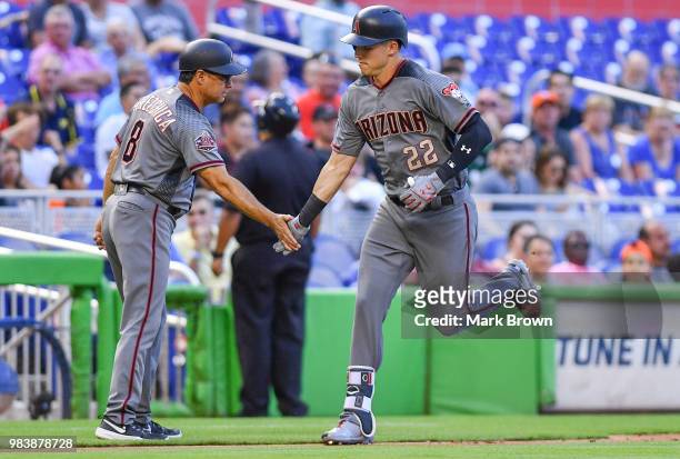 Jake Lamb of the Arizona Diamondbacks rounds third base after hitting a home run in the first inning during the game against the Miami Marlins at...