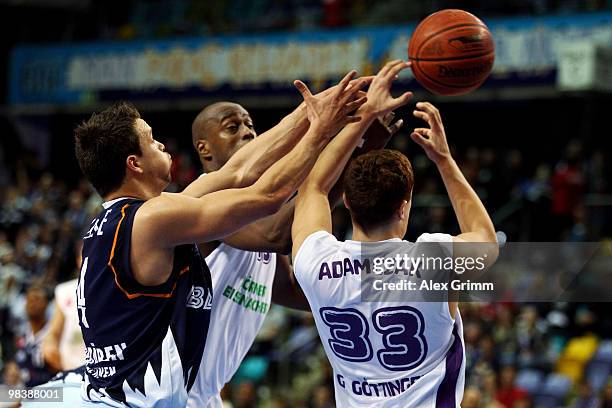 Jan Lipke of Bremerhaven is challenged by Michael Meeks and Nico Adamczak of Goettingen during the third place game between BG Goettingen and...