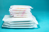 Sanitary pads and absorbent sheets on blue background