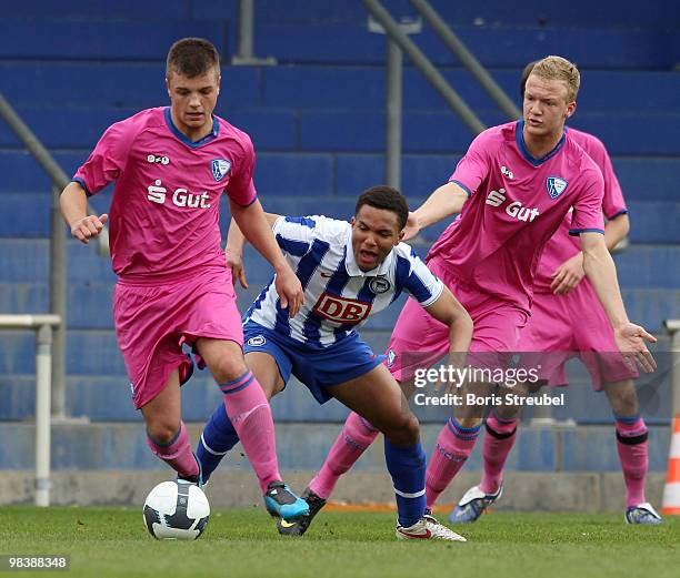 Jens-Enrique Gottschick of Berlin battles for the ball with Steven Behrens and Kevin Vogt of Bochum during the DFB Juniors Cup half final between...