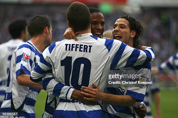 Caiuby of Duisburg celebrates the first goal with Christian Tiffert and Olcay Sahan during the Second Bundesliga match between MSV Duisburg and SpVgg...