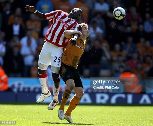 Abdoulaye Faye of Stoke City goes up for the ball against Kevin Doyle of Wolverhampton Wanderers during the Barclays Premier League match between...