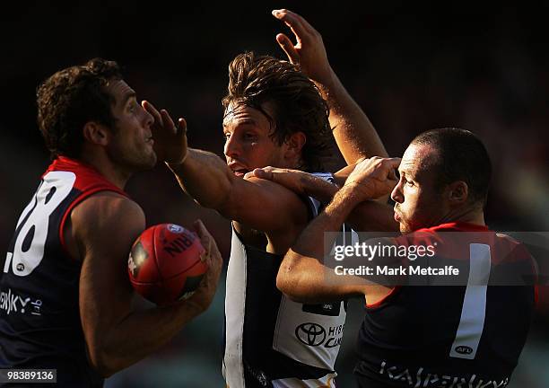 Joel McDonald of the Demons is challenged by Ivan Maric of the Crows during the round three AFL match between the Melbourne Demons and the Adelaide...