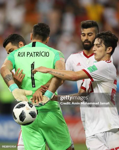 Iran players try to retrieve the ball from Rui Patricio of Portugal after Karim Ansarifard of Iran scored a goal during the 2018 FIFA World Cup...