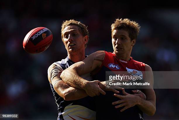 Ricky Petterd of the Demons and Chris Schmidt of the Crows challenge for the ball during the round three AFL match between the Melbourne Demons and...