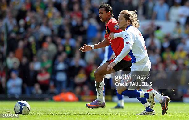 Blackburn Rovers' Spanish defender Mi­chel Salgado vies with Manchester United's Portuguese midfielder Nani during the English Premier League...