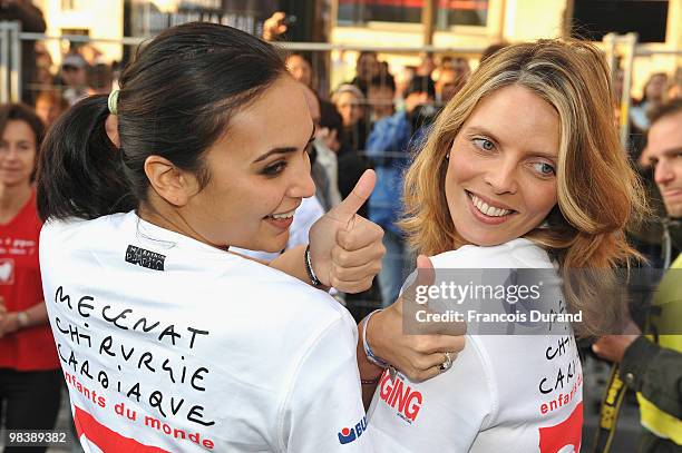 Valerie Begue and Sylvie Tellier pose at the start of the Paris Marathon 2010 on April 11, 2010 in Paris, France.