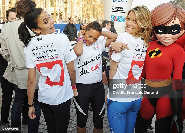 Valerie Begue, Hermine of Clermont-Tonnerre and Sylvie Tellier pose with the cartoon character Elastigirl at the start of the Paris Marathon 2010 on...